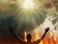 man with hands raised towards clouds and sun with image of religious figure on it