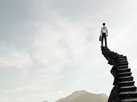 person on top of a staircase overlooking a mountain